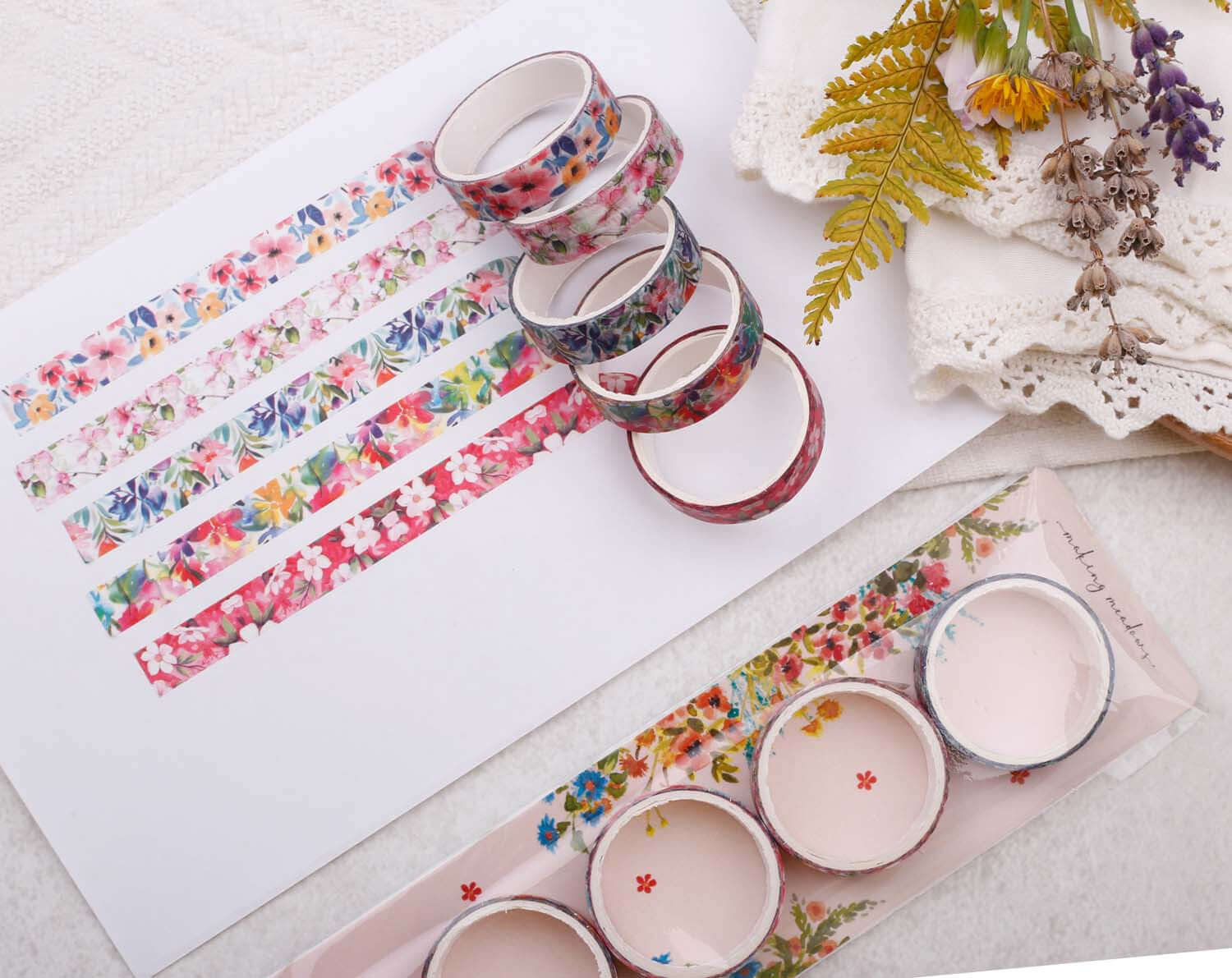 Tropical Floral Washi Tape variety pack displayed with floral patterns and craft supplies on a table.