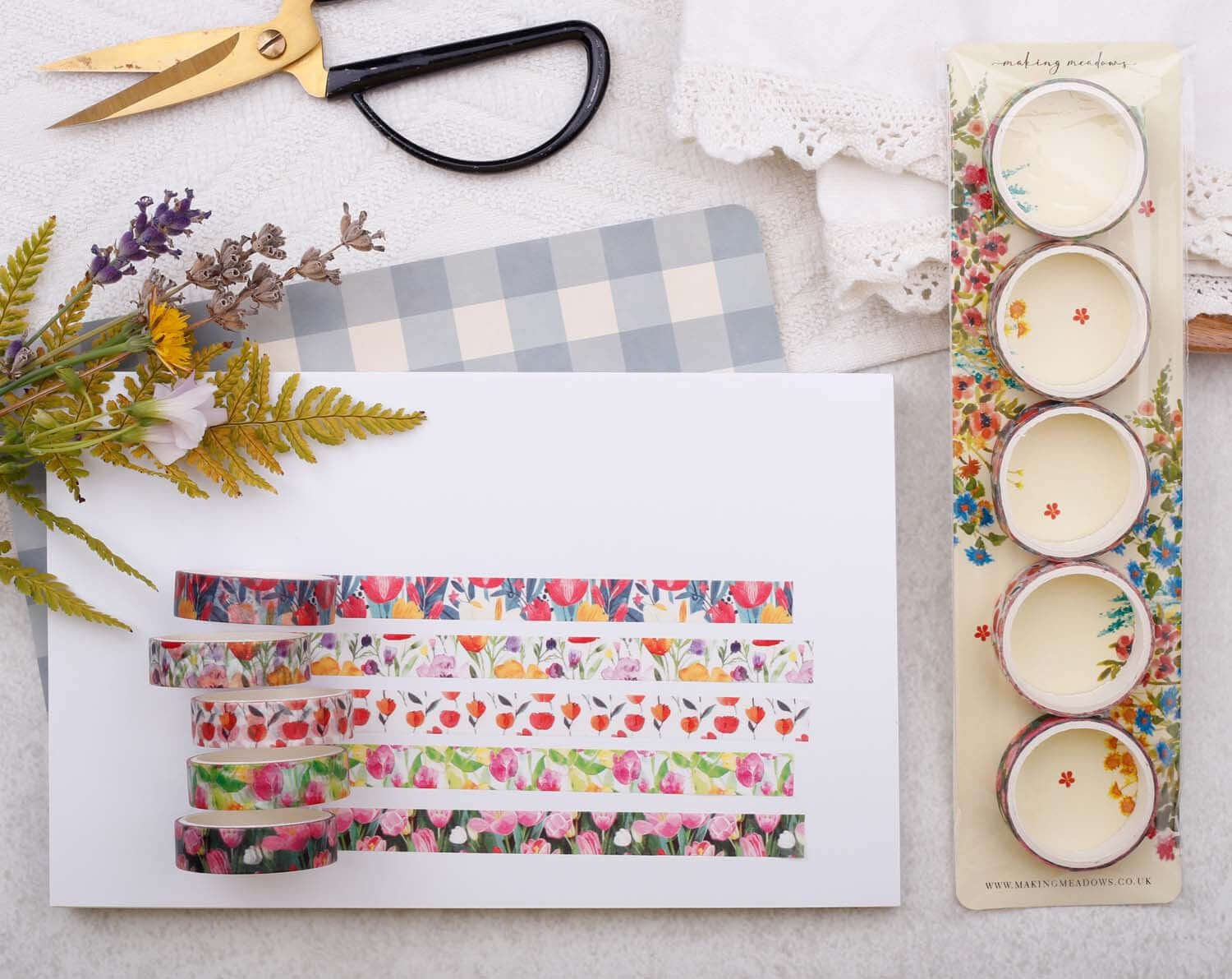 Tulip Floral Washi Tape Variety Pack displayed with scissors, floral designs, and a craft background.