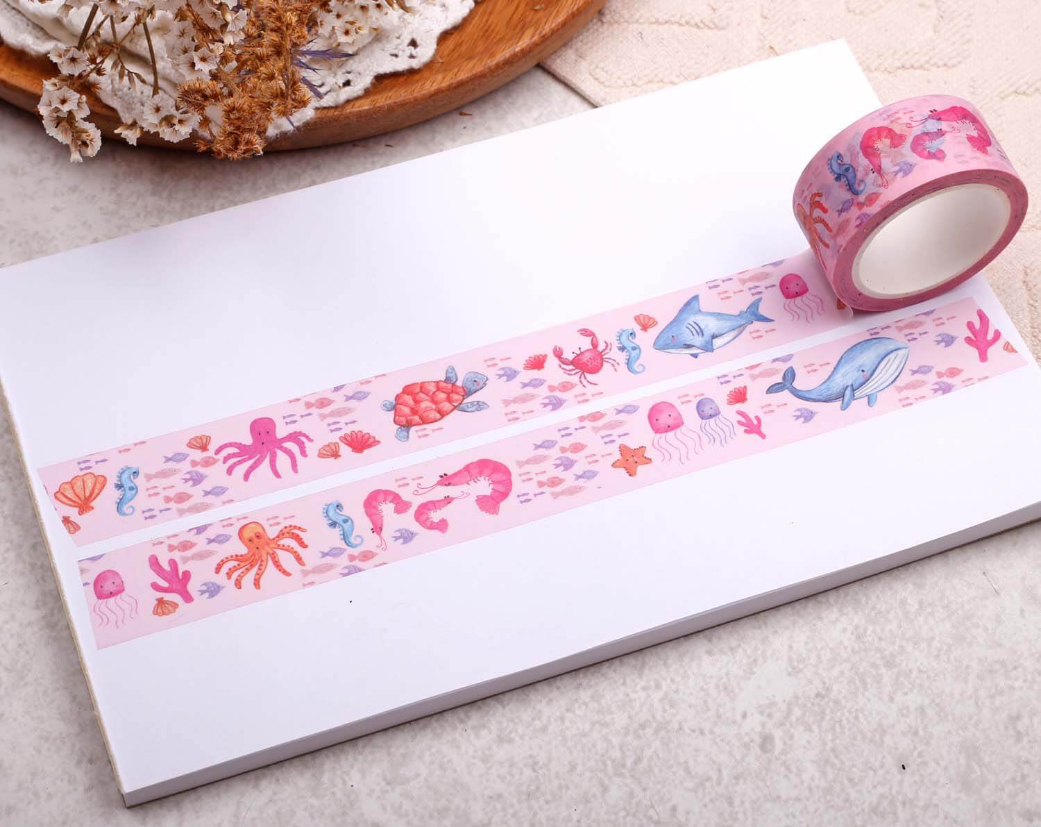 Under The Sea Washi Tape featuring colorful ocean creatures on a white background with a roll beside it.