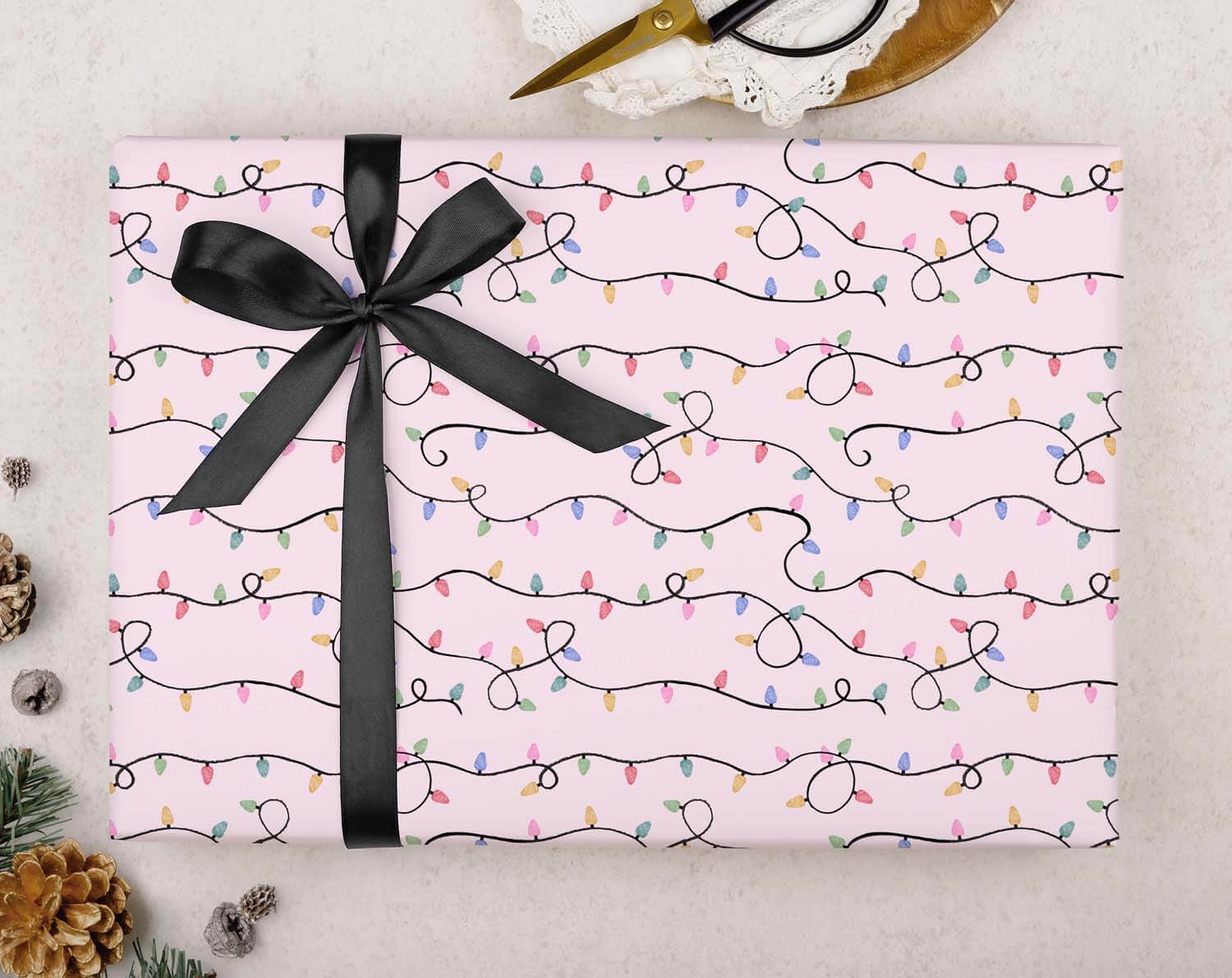 Vintage Christmas Lights Wrapping Paper with colorful lights and black ribbon on a festive background.