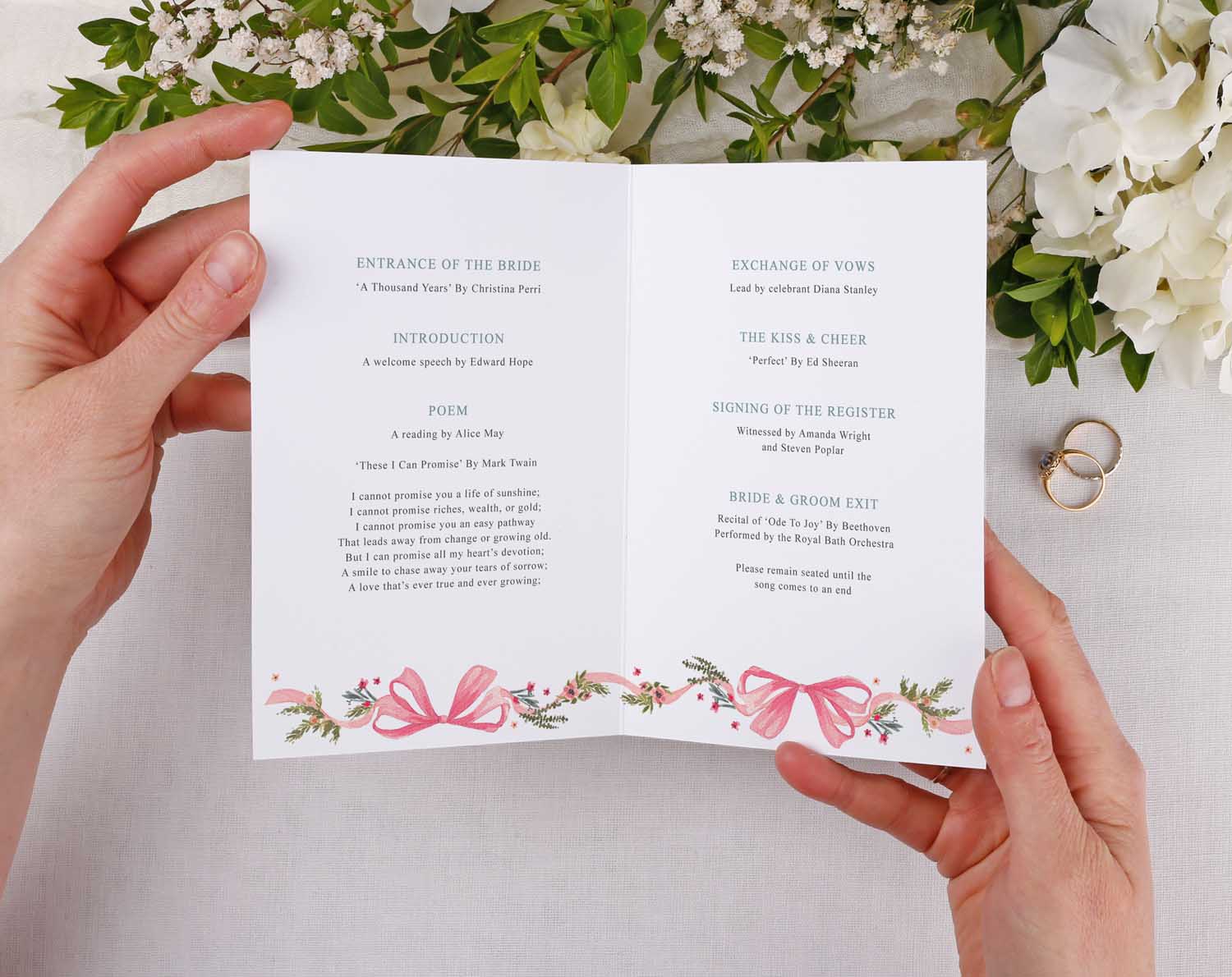 Vintage Order Of Service booklet opened, featuring floral design and pink ribbon. Perfect for wedding ceremony.