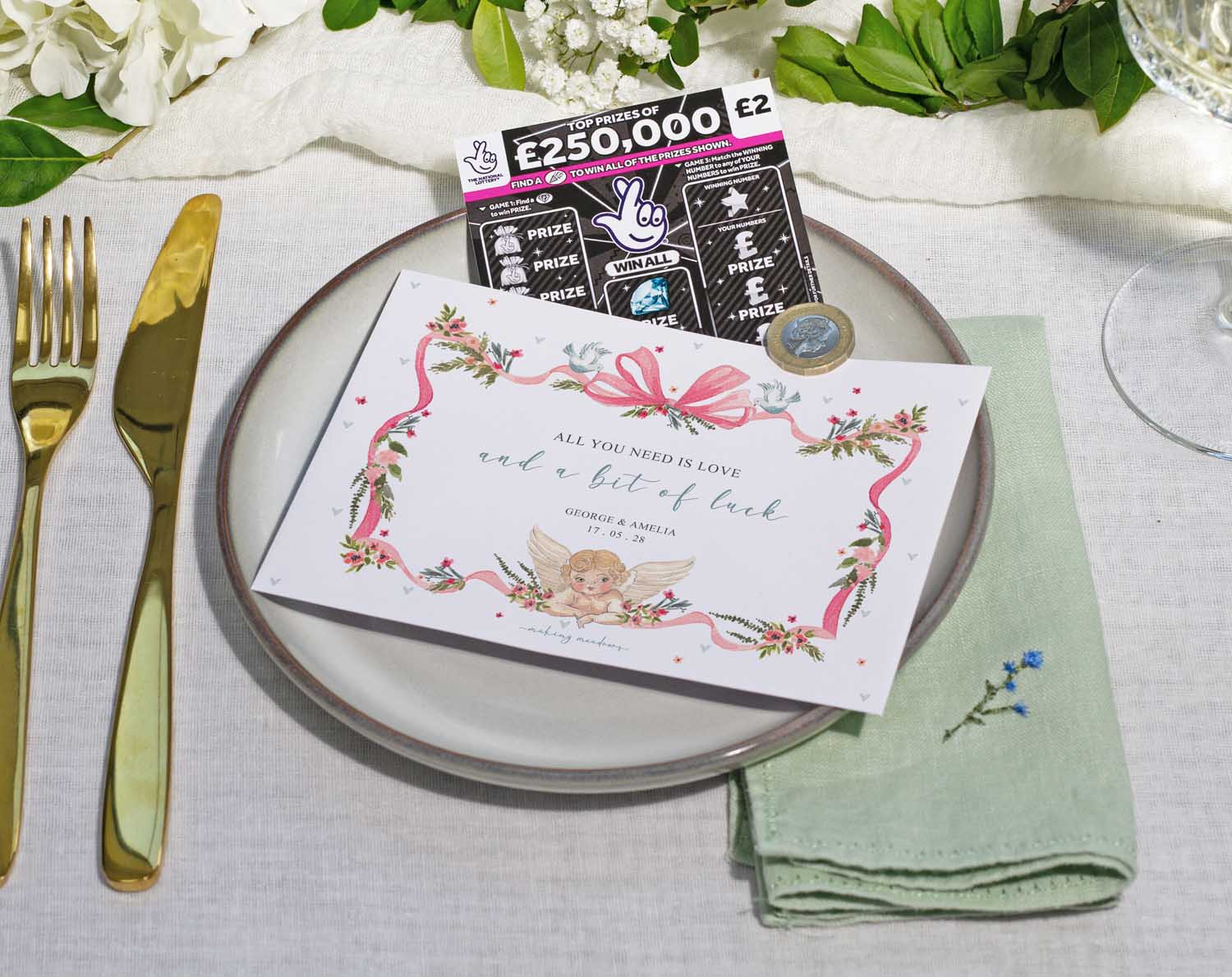 Vintage Scratch Card Envelopes for wedding favours displayed on a plate with cutlery and a floral arrangement.