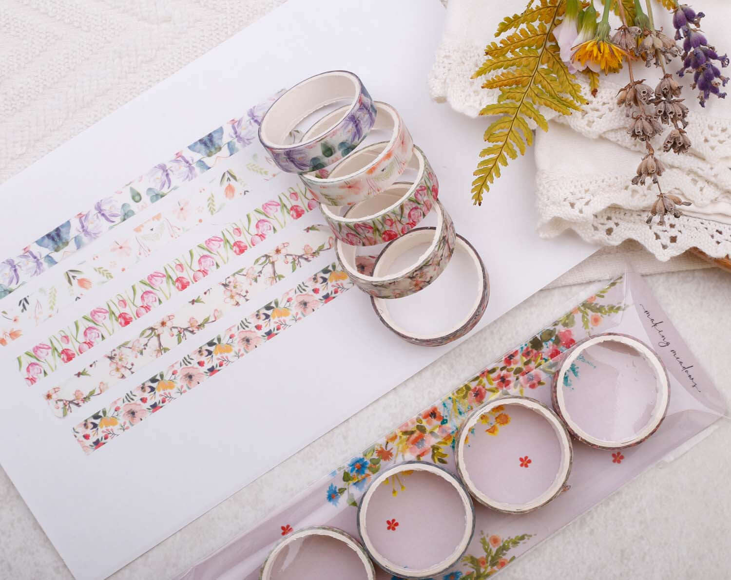 Watercolour Floral Washi tape variety pack displayed with floral designs and additional craft supplies on a soft backdrop.
