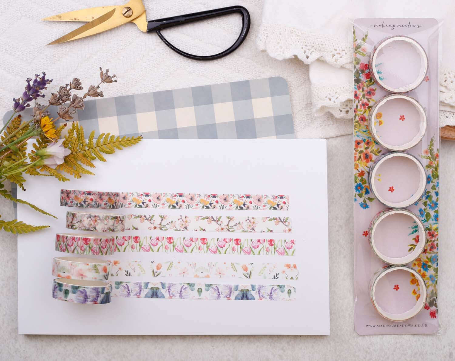 Watercolour Floral Washi variety pack featuring five rolls of floral washi tape displayed with stationery accessories.