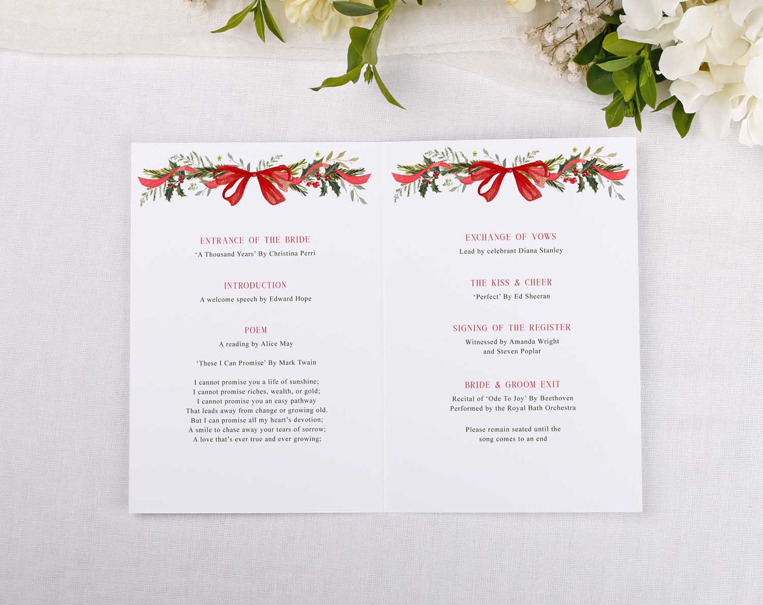 Winter Order Of Service booklet with festive botanical Christmas design and red bow, guiding guests through the wedding ceremony.