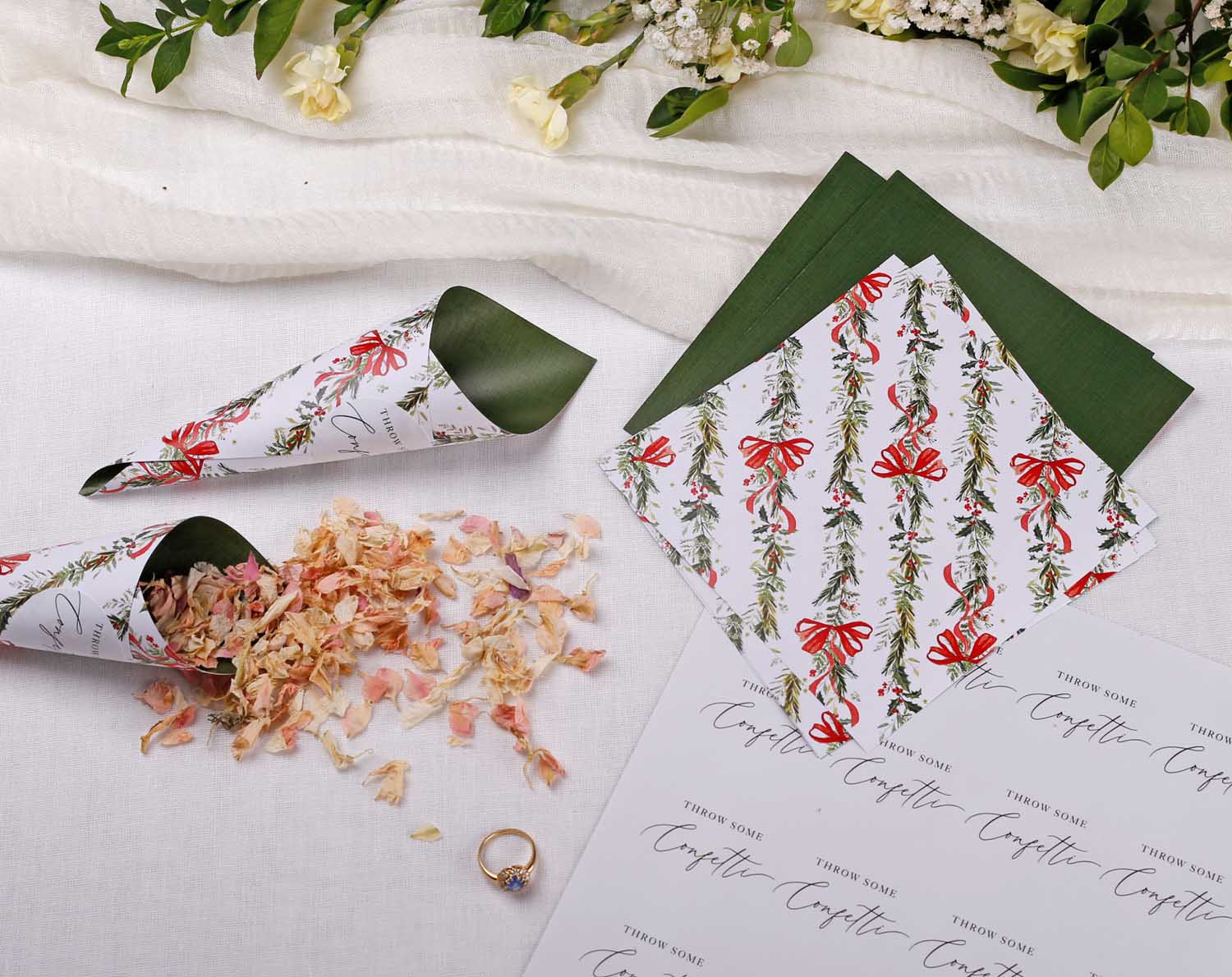 Winter Wedding Confetti Cones displayed with flower petals and decorative paper for a festive wedding ceremony.
