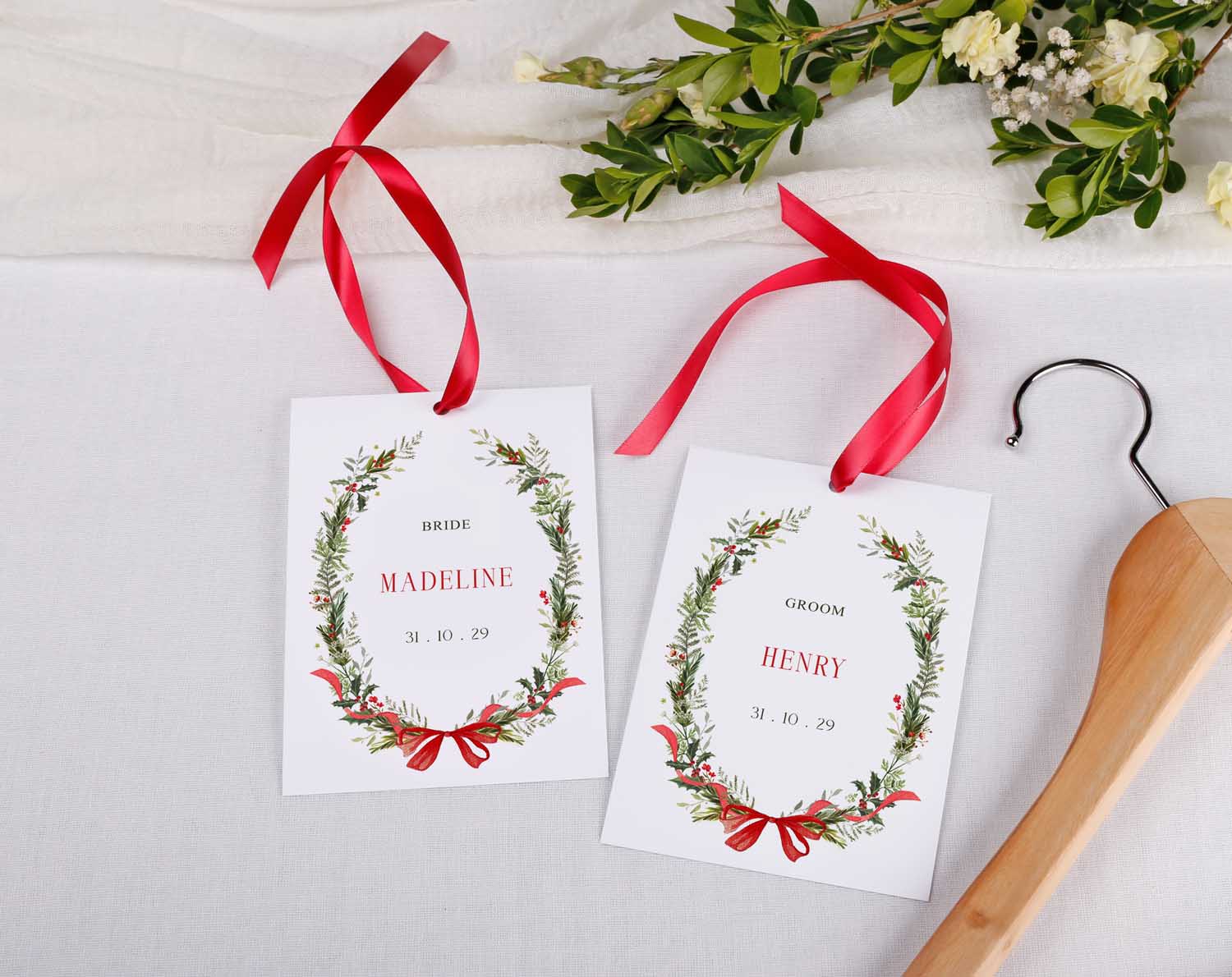 Winter Wedding Hanger Tags for bridal party featuring personalized designs for bride and groom with red ribbons.