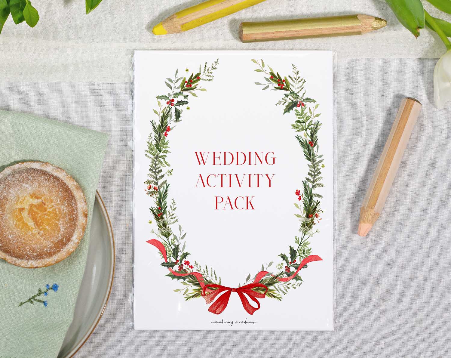 Winter Wedding Kids Activity Pack on a table with a dessert and colored pencils, perfect for entertaining children at weddings.