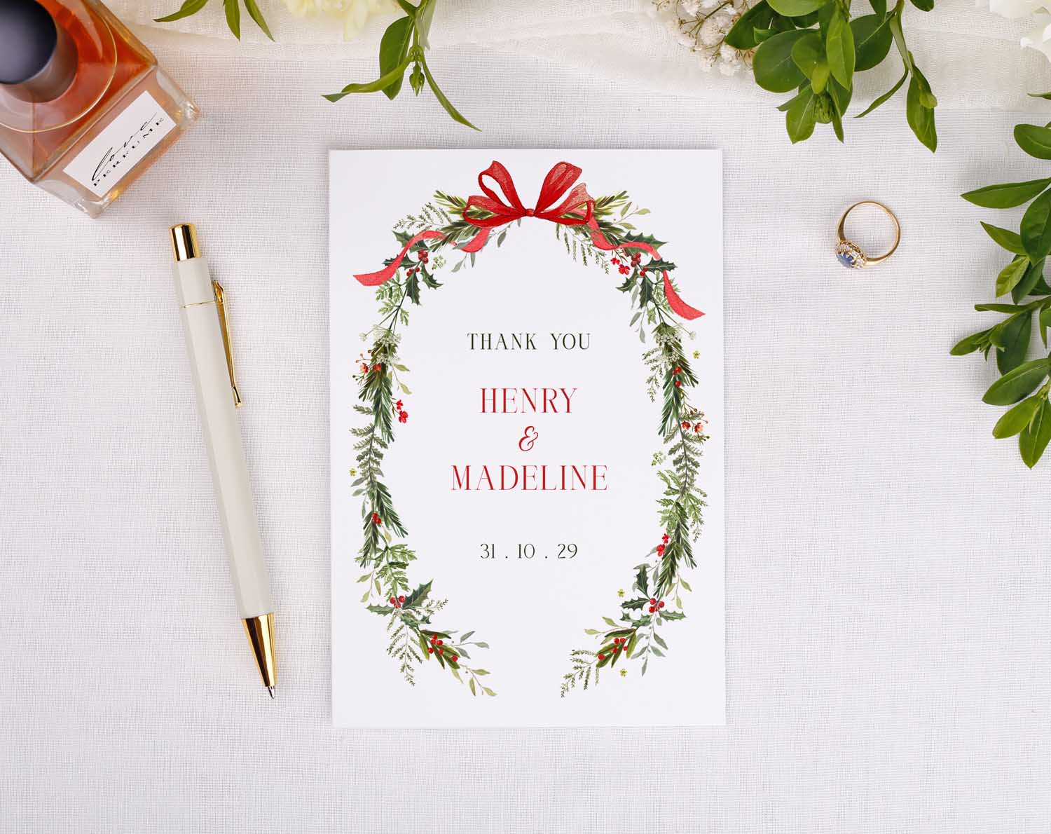 Winter Wedding Thank You Cards featuring a floral design with names Henry and Madeline and a festive bow.