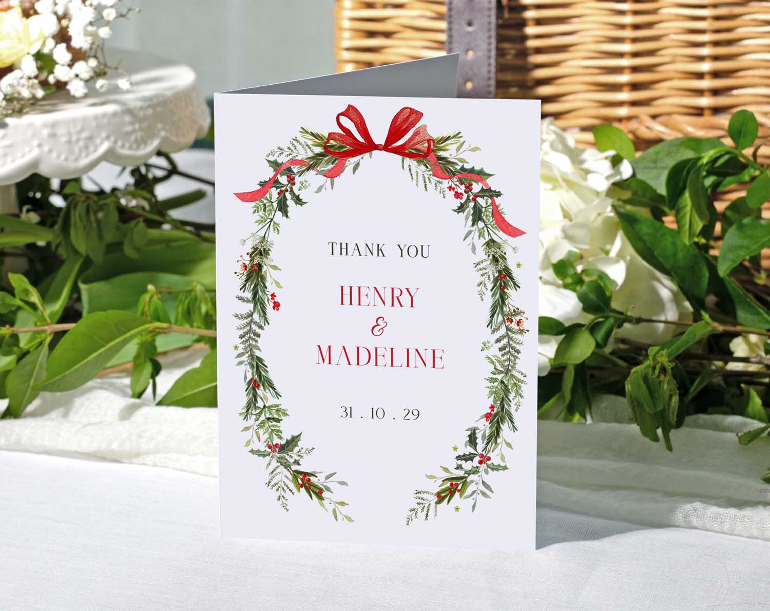 Winter Wedding Thank You Cards featuring red ribbons and greenery, thanking guests from Henry and Madeline.