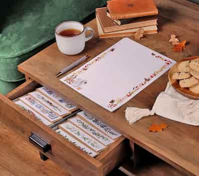 desk with a collection of writing paper and stationery on