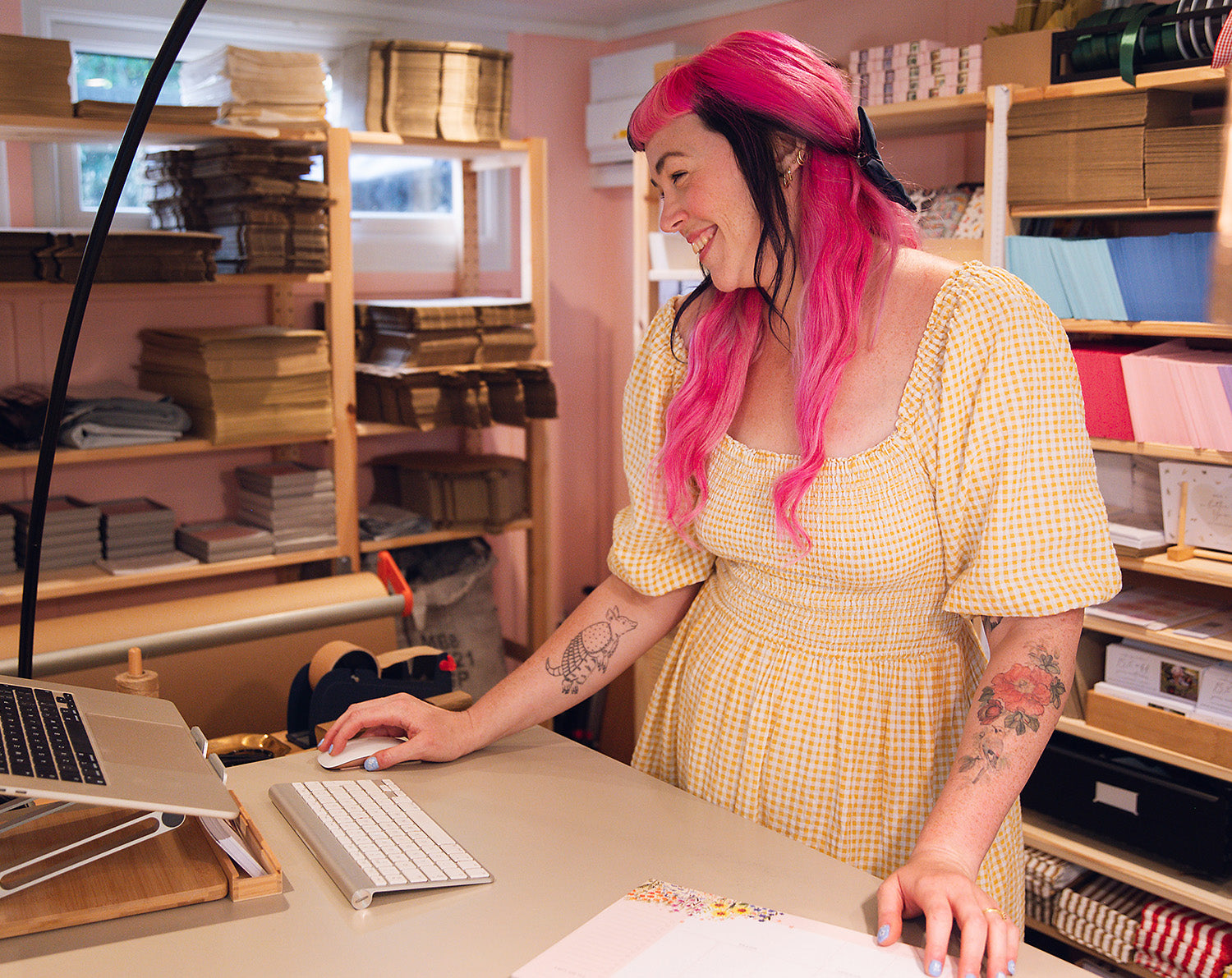 Samantha standing in her studio Making Meadows, packing eco friendly stationery orders