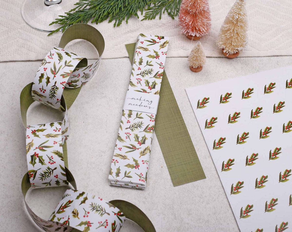 Holly Christmas Paper Chains Garland displayed with festive decorations and patterned paper.