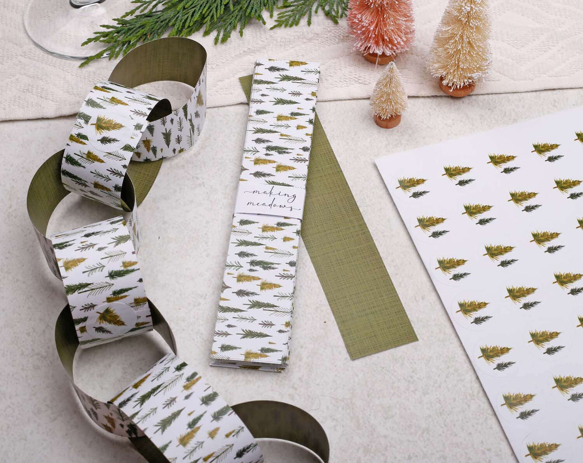 Forest Christmas Paper Chains garland displayed with decorative trees and patterned wrapping paper.