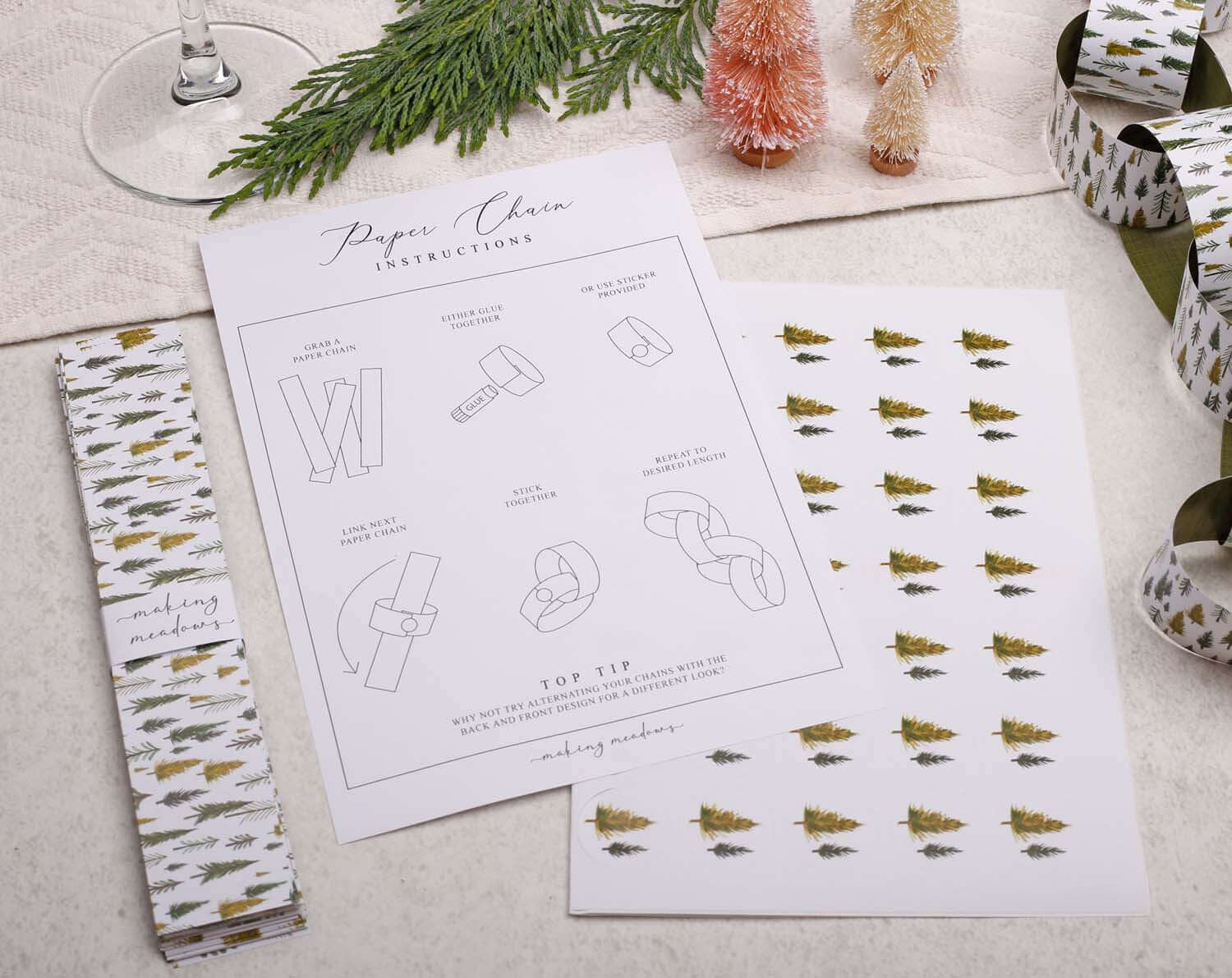 Image of instructions for making Forest Christmas Paper Chains with decorative paper and greenery.