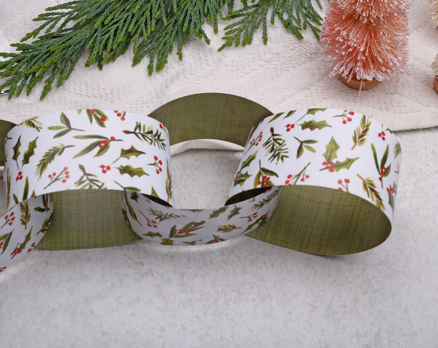 Holly Christmas Paper Chains garland featuring festive designs with holly leaves and red berries.