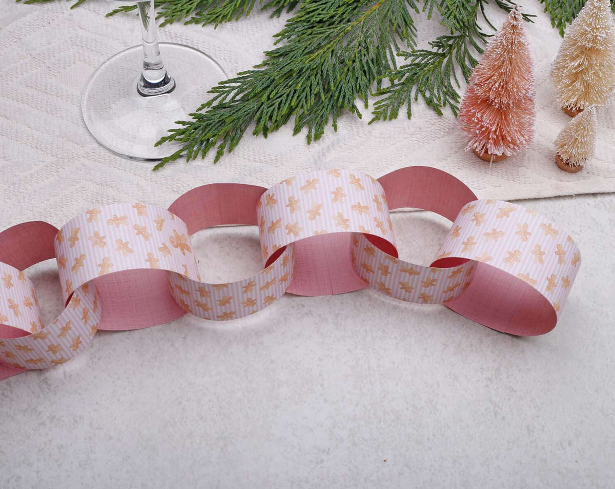 Pink Christmas Paper Chains showcasing festive decoration, with pink and white design, surrounded by holiday elements.