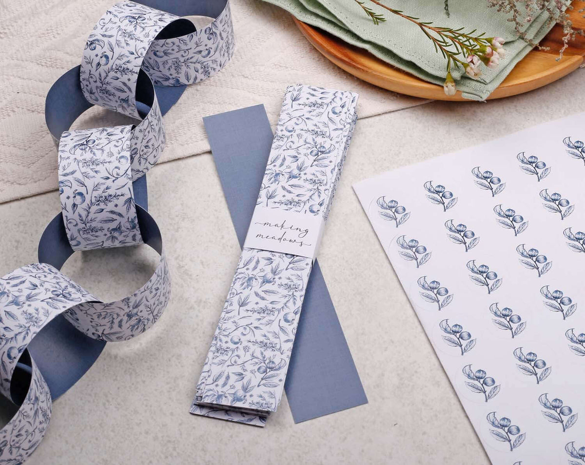 Blue Garden Paper Chains Garland displayed with patterned paper and matching accessories.