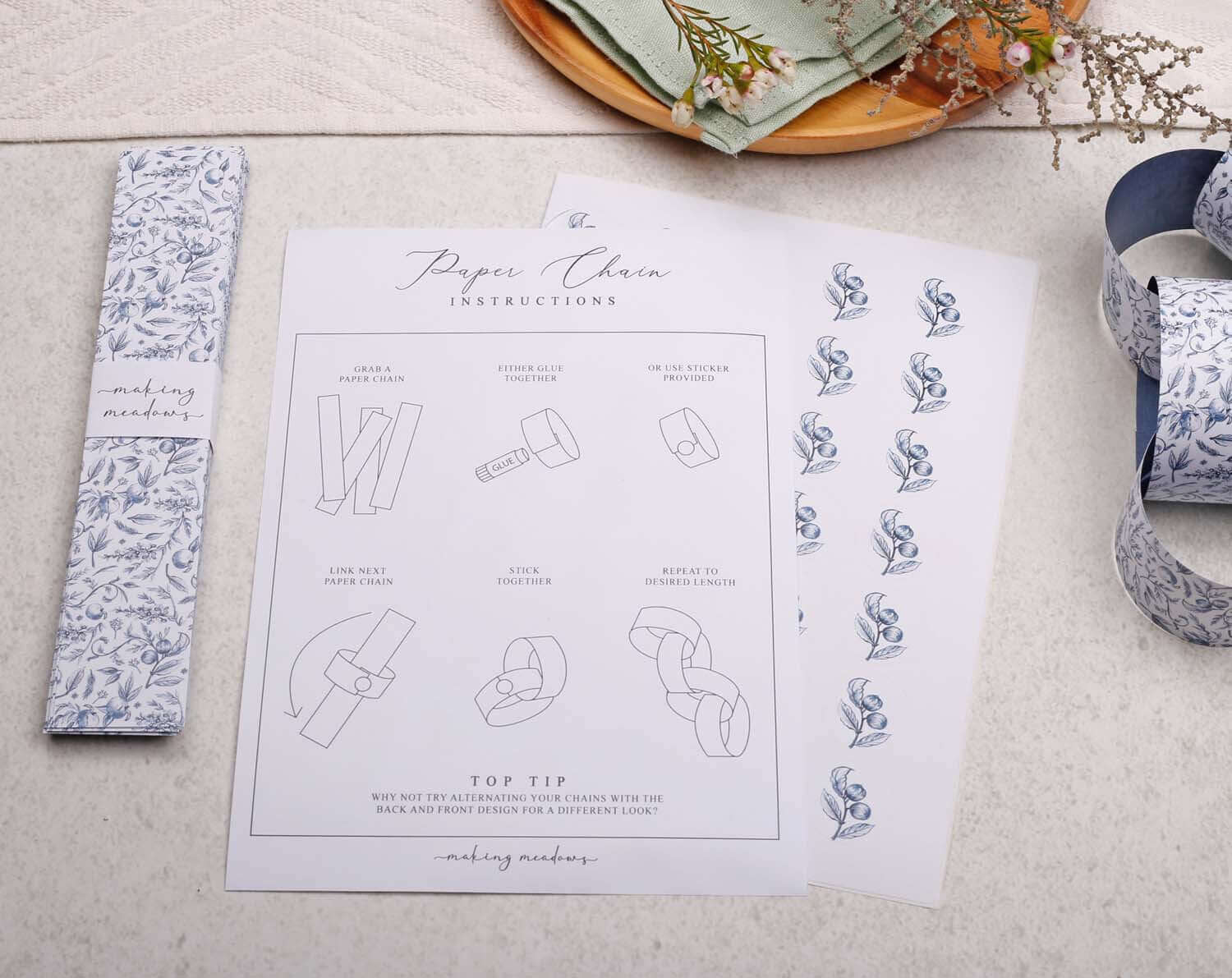 Blue Garden Paper Chains instructions with decorative patterns and assembly tips on a light background.
