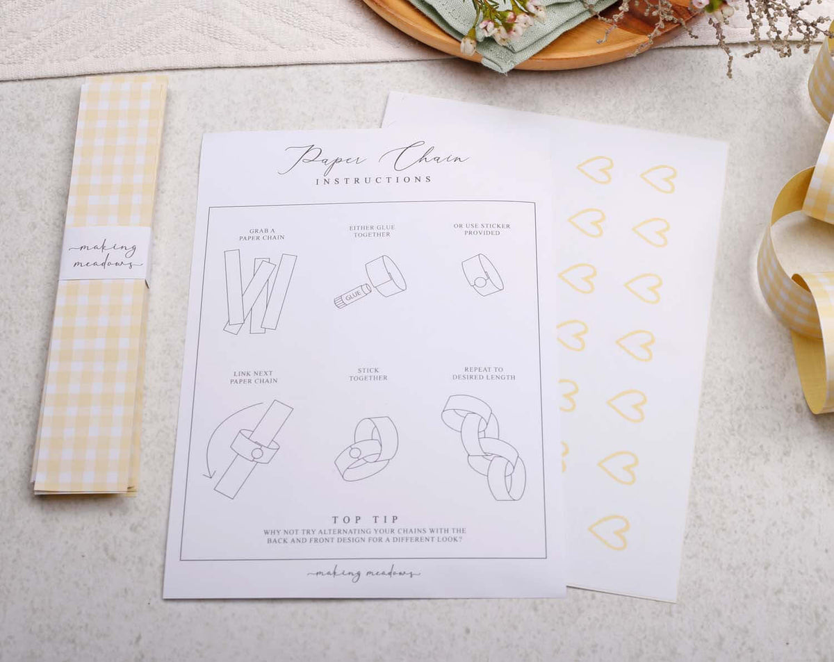 Instructions for assembling Yellow Gingham Paper Chains with diagram and heart stickers.