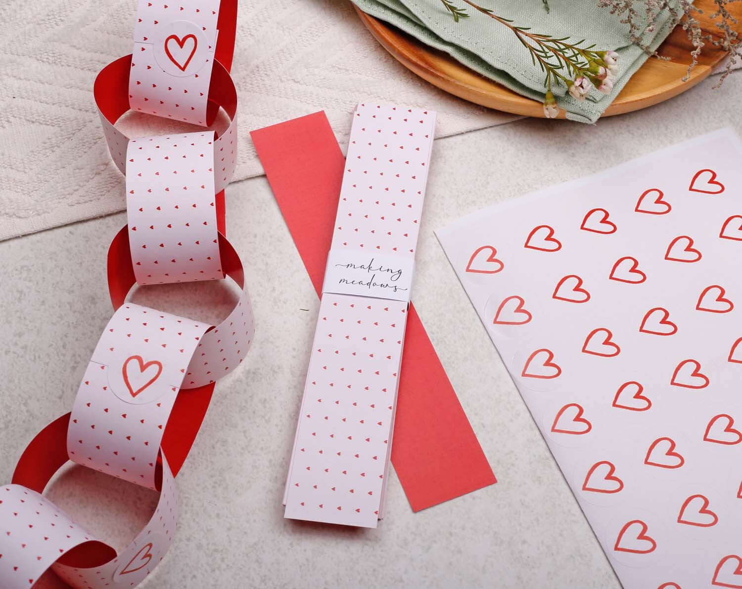 Pink Heart Paper Chains garland displayed with red and white paper, perfect for festive decorations.