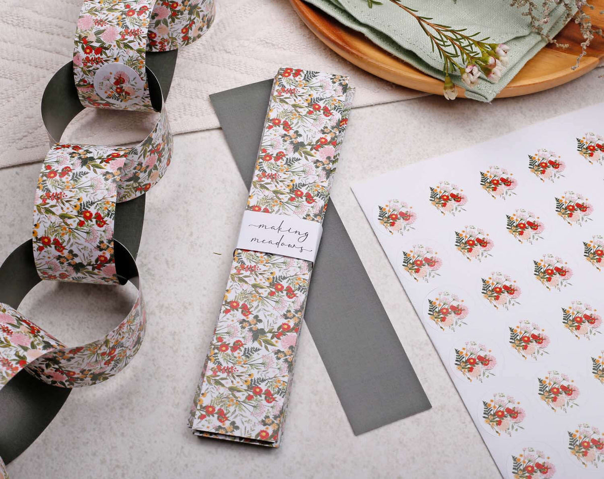 Boho Floral Paper Chains Garland featuring floral designs, displayed with coordinating paper and crafting materials.