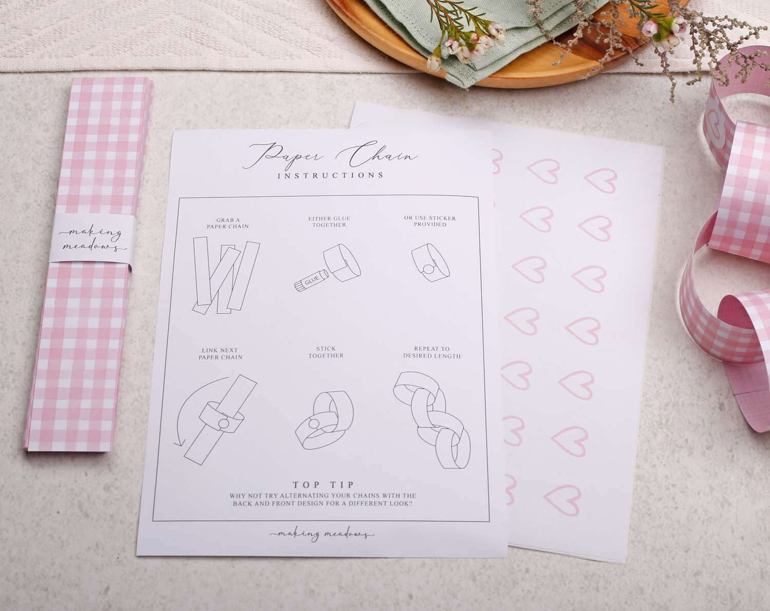 Instructions for making Pink Gingham Paper Chains with illustrated steps and tools for assembly.