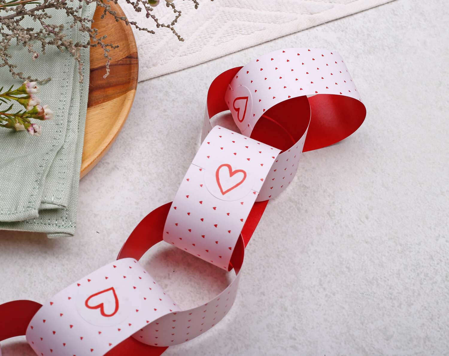 Pink Heart Paper Chains garland decor featuring red and white paper links with heart patterns on a light background.