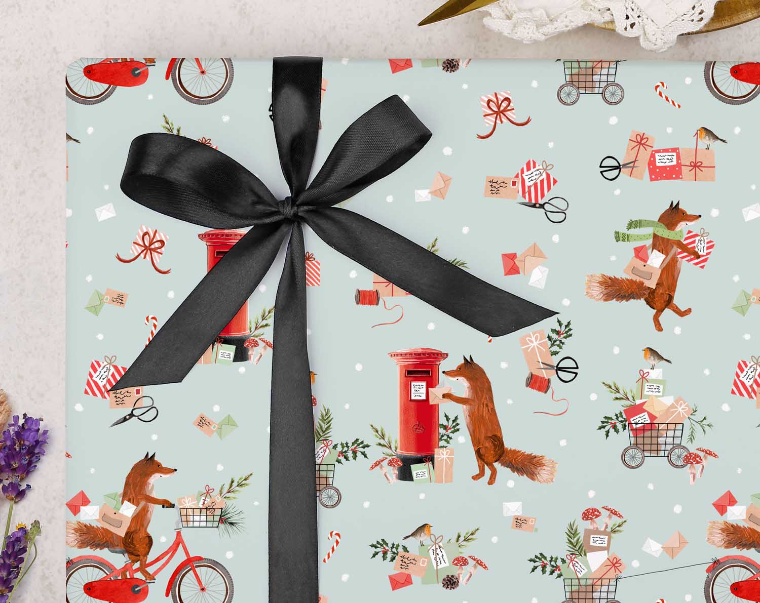 festive Christmas wrapping paper is filled with whimsical fox postman collecting mail and posting letters