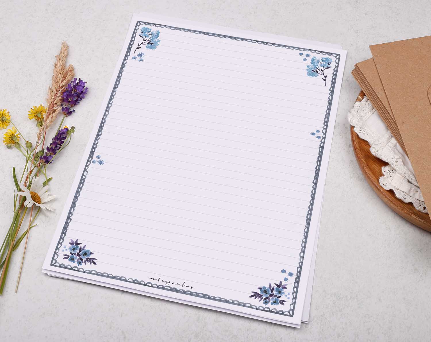 A4 writing paper with blue floral scalloped edge border. Stationery designed by Making Meadows