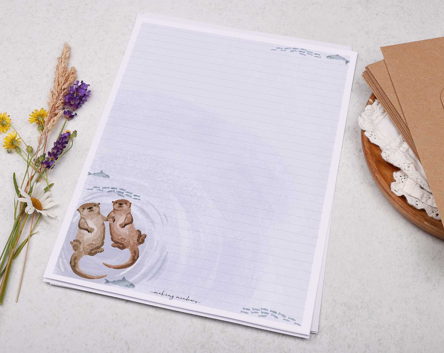 A4 writing paper with otters holding hands. Stationery designed by Making Meadows