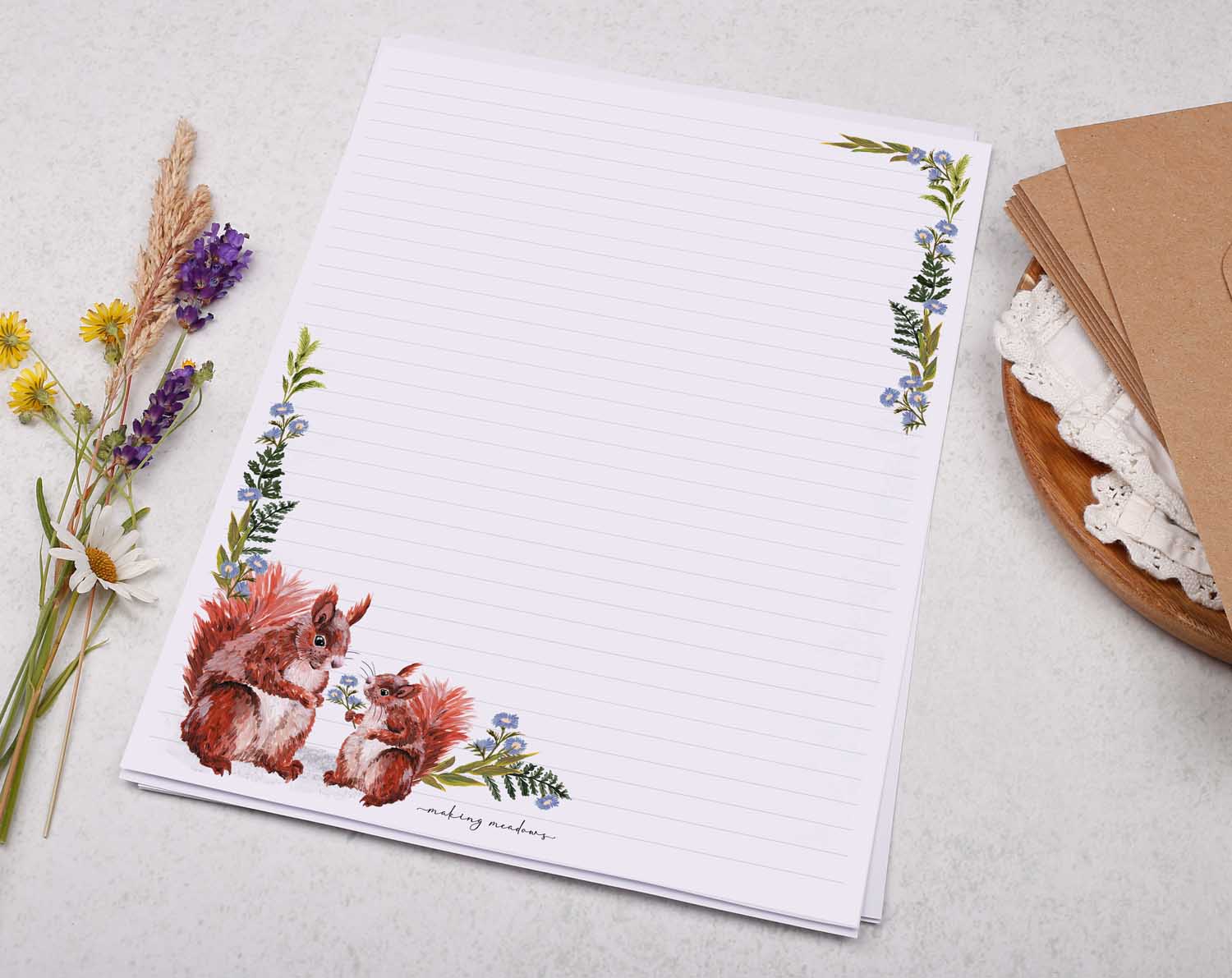 A4 writing paper with red squirrels and blue floral border. Stationery designed by Making Meadows