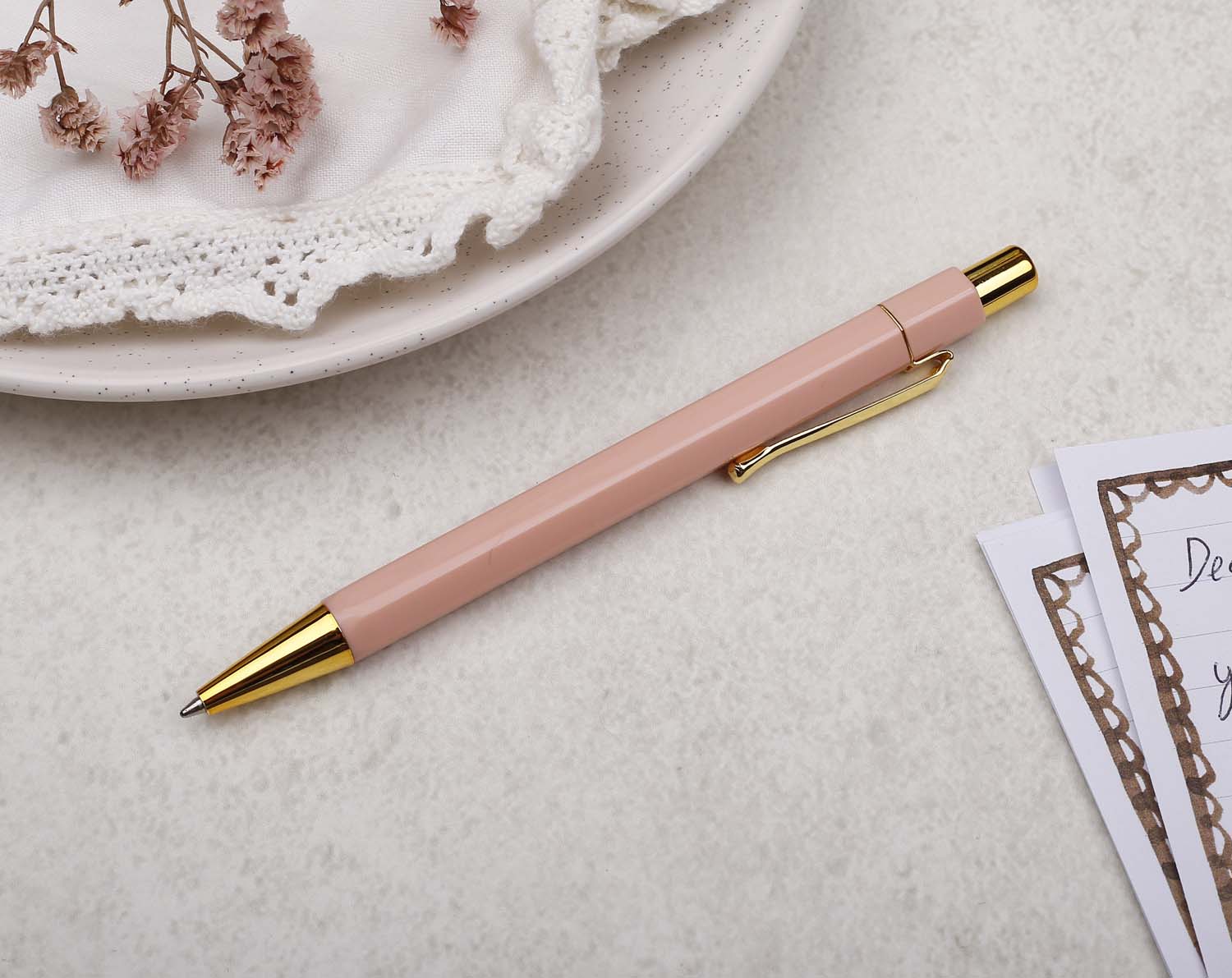A premium peach and gold pen with ballpoint tip and hexagonal barrel detail