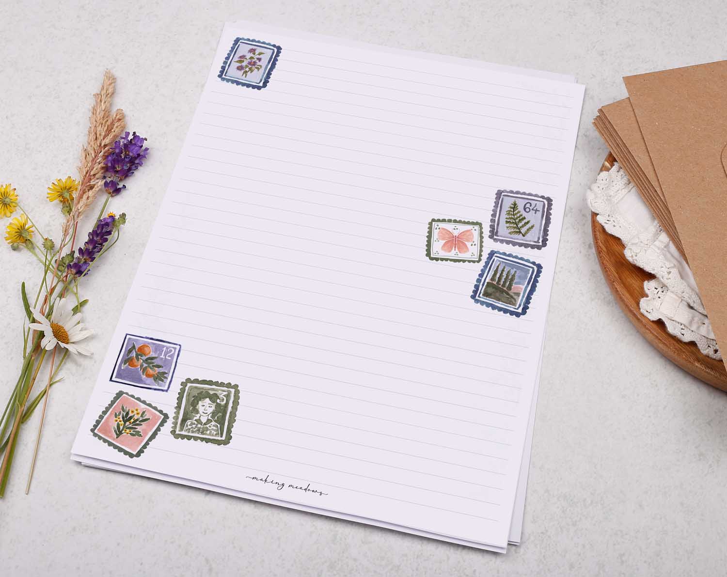 A4 letter writing paper sheets with a pretty scattering of floral postage stamps. The delicate floral watercolour stamp designs cascade around the letter paper edge.