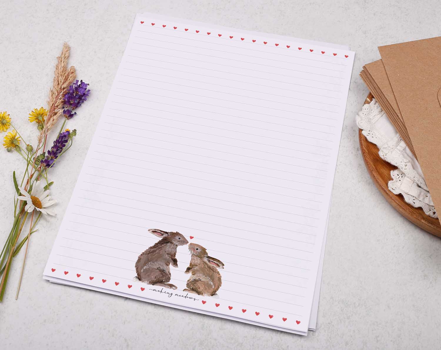 A4 letter writing paper sheets with a pair of loved up bunny rabbits. The delicate red heart design cascades around the letter paper edge.