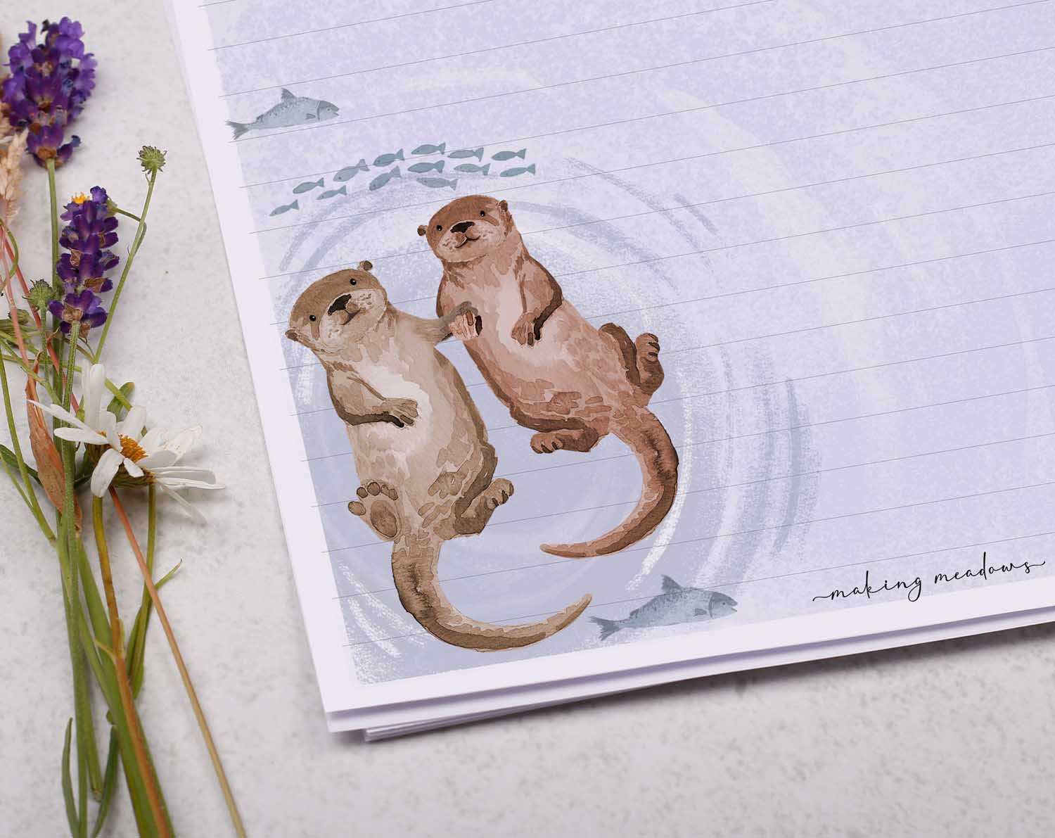 A4 letter writing paper sheets with a cute otter holding hands while floating down a river with fish. 