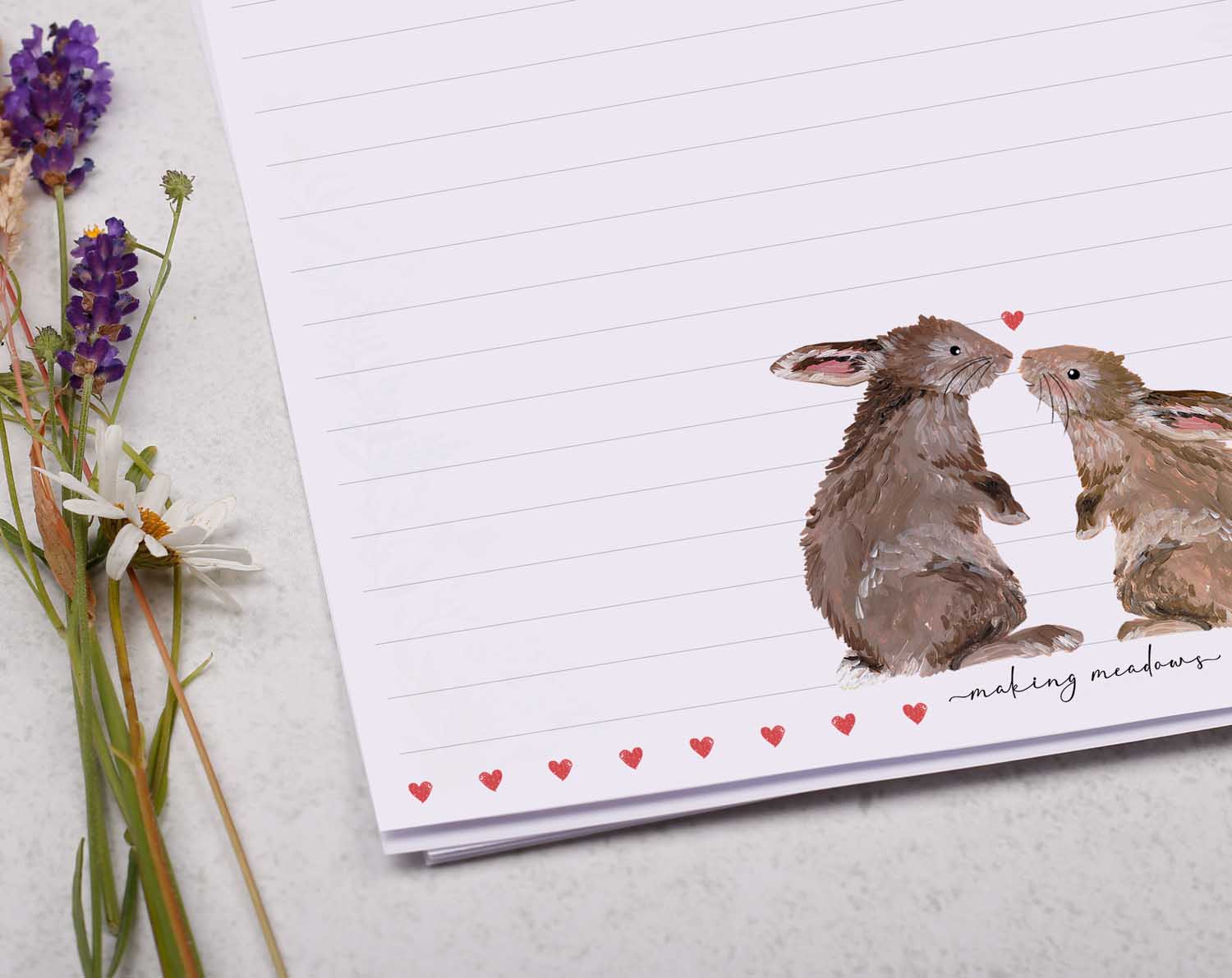 A4 letter writing paper sheets with a pair of loved up bunny rabbits. The delicate red heart design cascades around the letter paper edge.