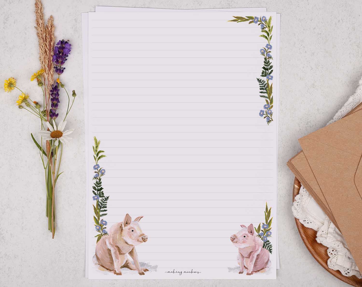 A4 letter writing paper sheets with a cute pair of farmyard pigs and a delicate blue floral watercolour border cascading around the letter paper edge.