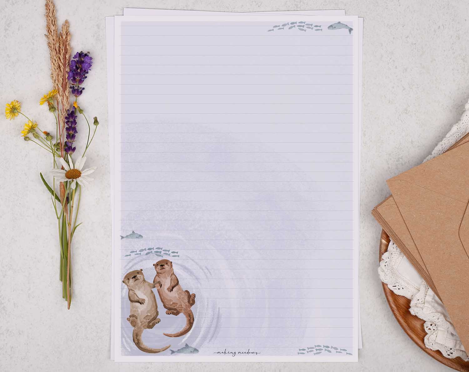A4 letter writing paper sheets with a cute otter holding hands while floating down a river with fish. 