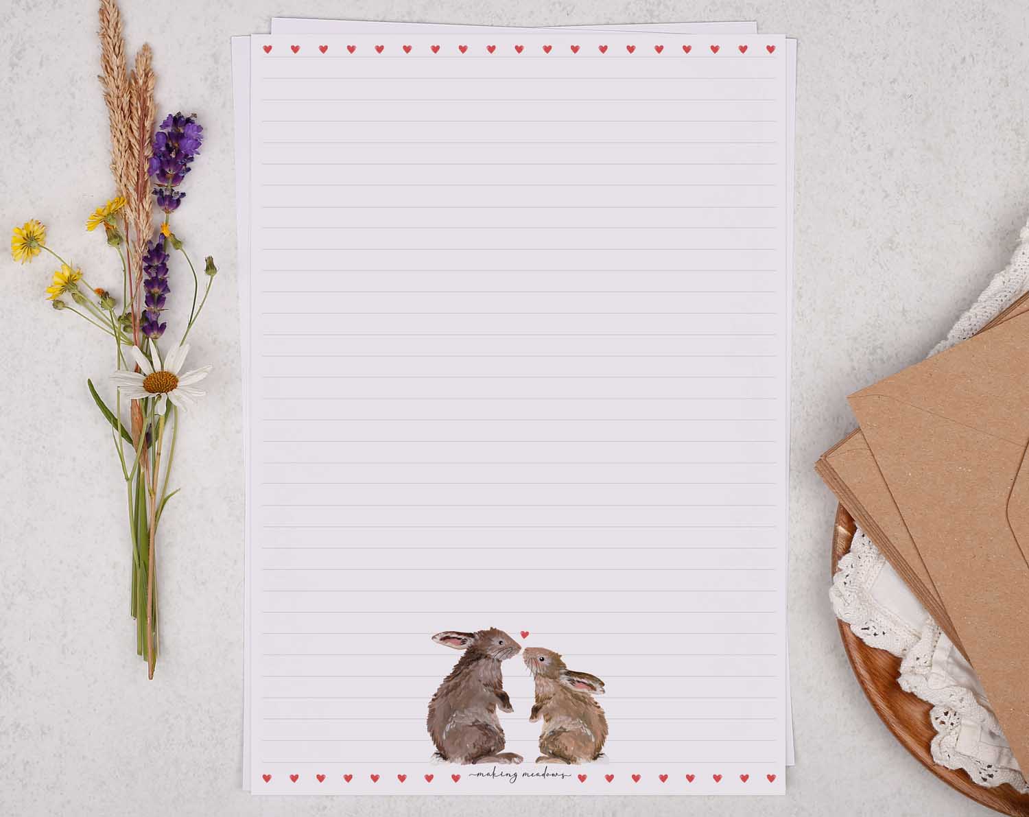 A4 letter writing paper sheets with a pair of loved up bunny rabbits. The delicate red heart design cascades around the letter paper edge.