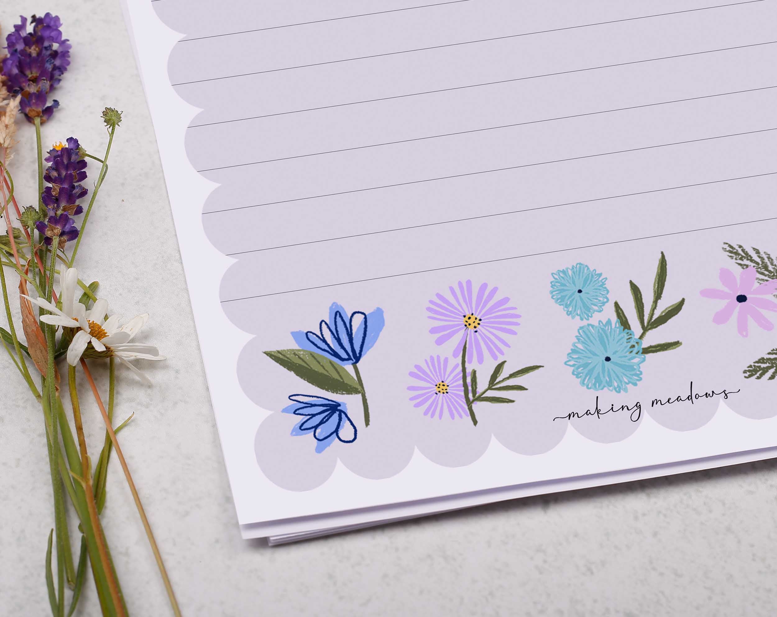 Premium personalised A5 letter writing paper set with beautiful lilac flowers along the bottom and a super cute scalloped edge border. 