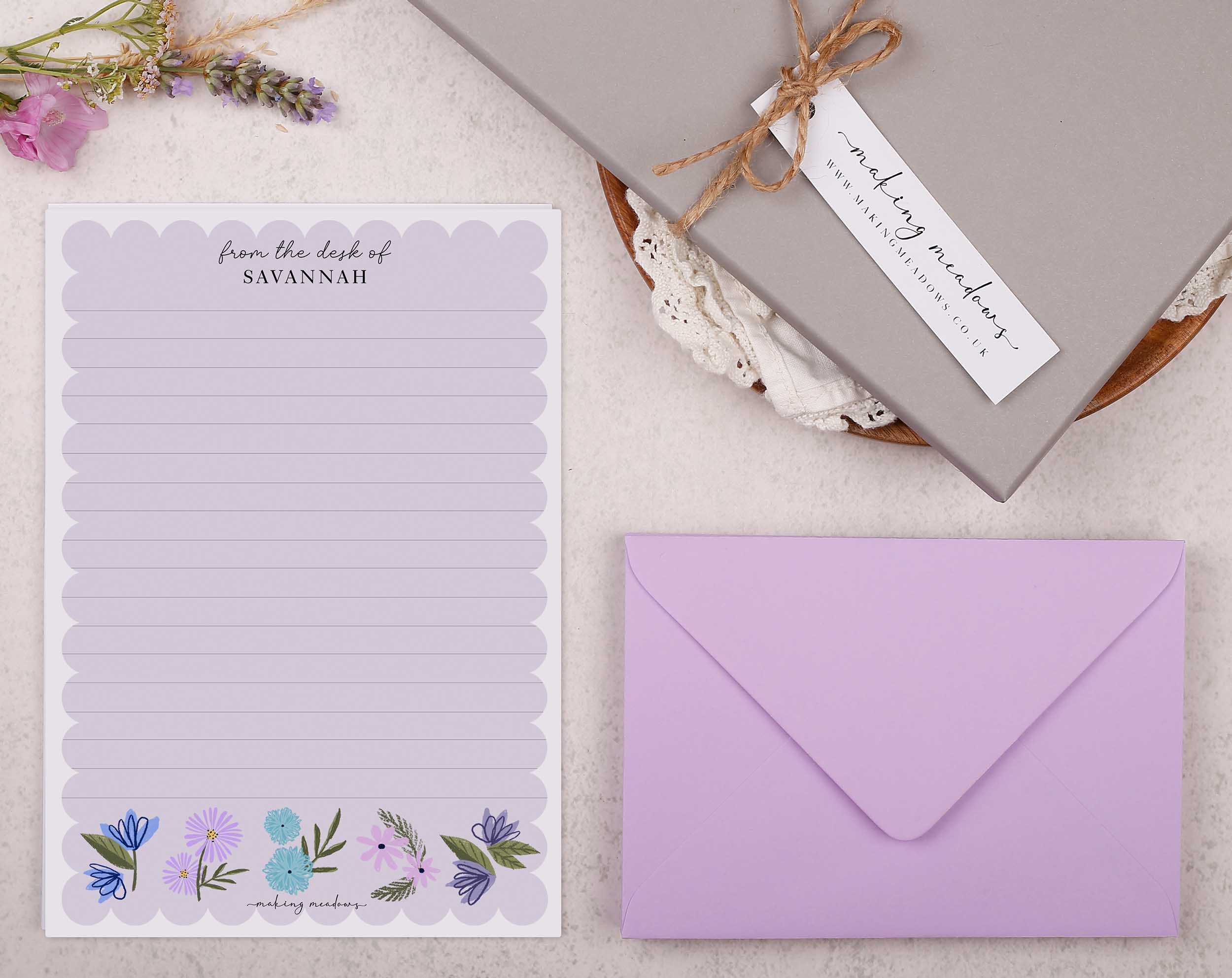 Premium personalised A5 letter writing paper set with beautiful lilac flowers along the bottom and a super cute scalloped edge border. 