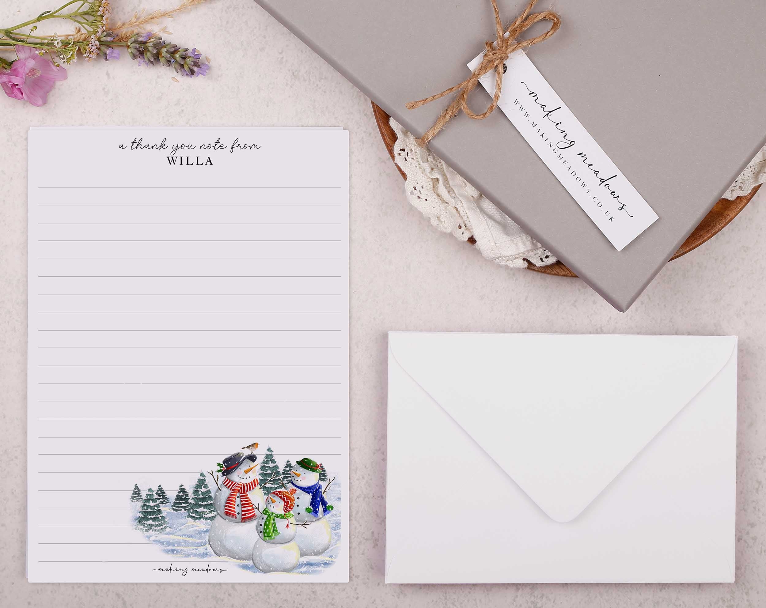 Premium personalised A5 letter writing paper set with a family of snowmen in the forest.