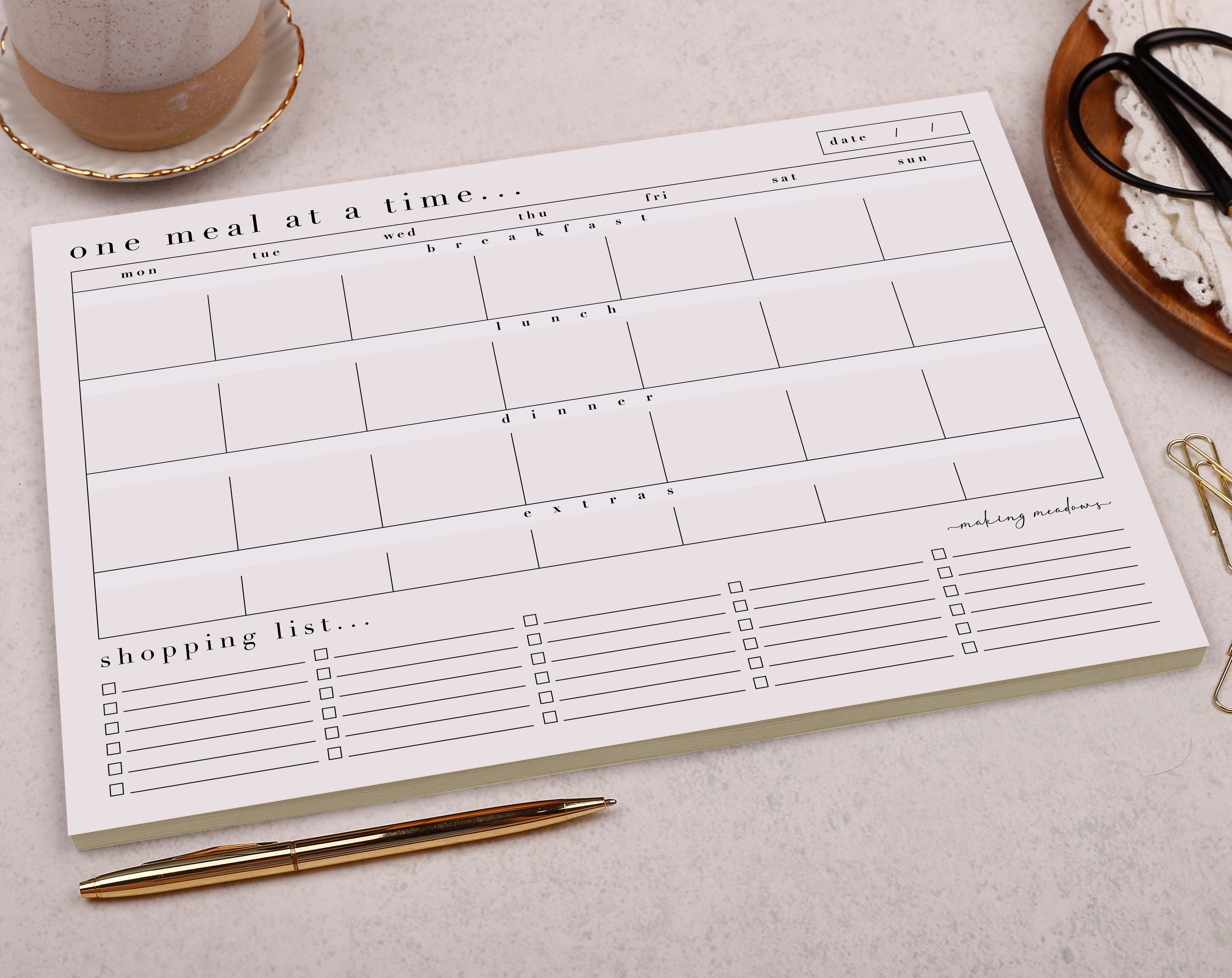 An elegant and simple, light pink tear off weekly meal planner pad with 50 pages