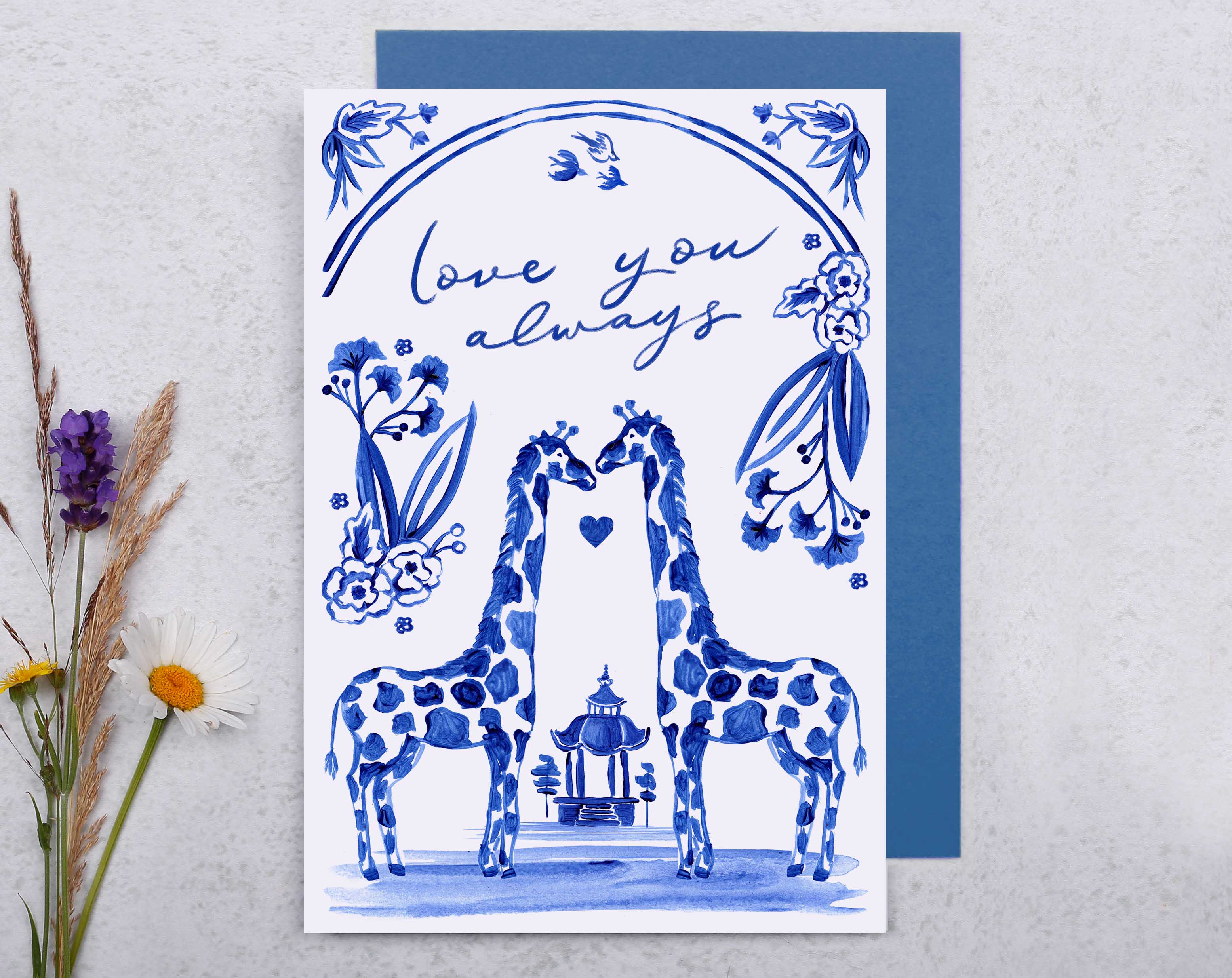 A blue porcelain inspired Anniversary Card with 2 giraffes in love, surrounded by hand painted flowers.