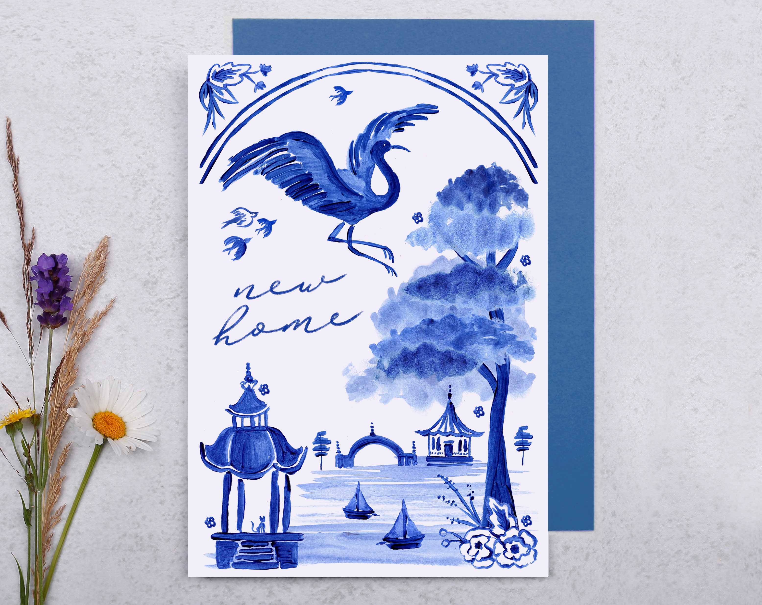 A blue porcelain inspired New Home Card with hand painted bird flying across a beautiful oriental landscape. 
