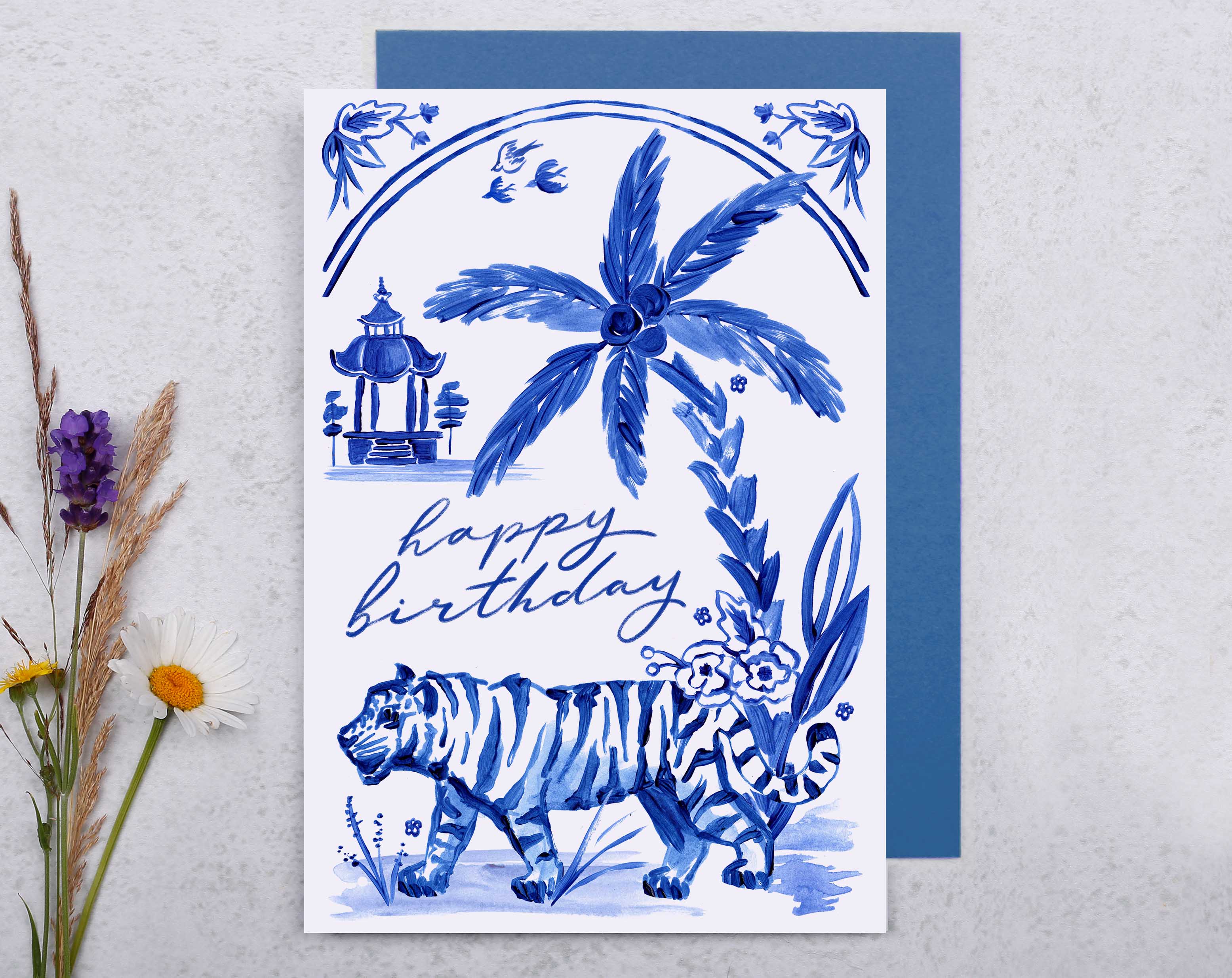 A blue porcelain inspired Happy Birthday Card with a tiger surrounded by palm trees and tropical flowers. 