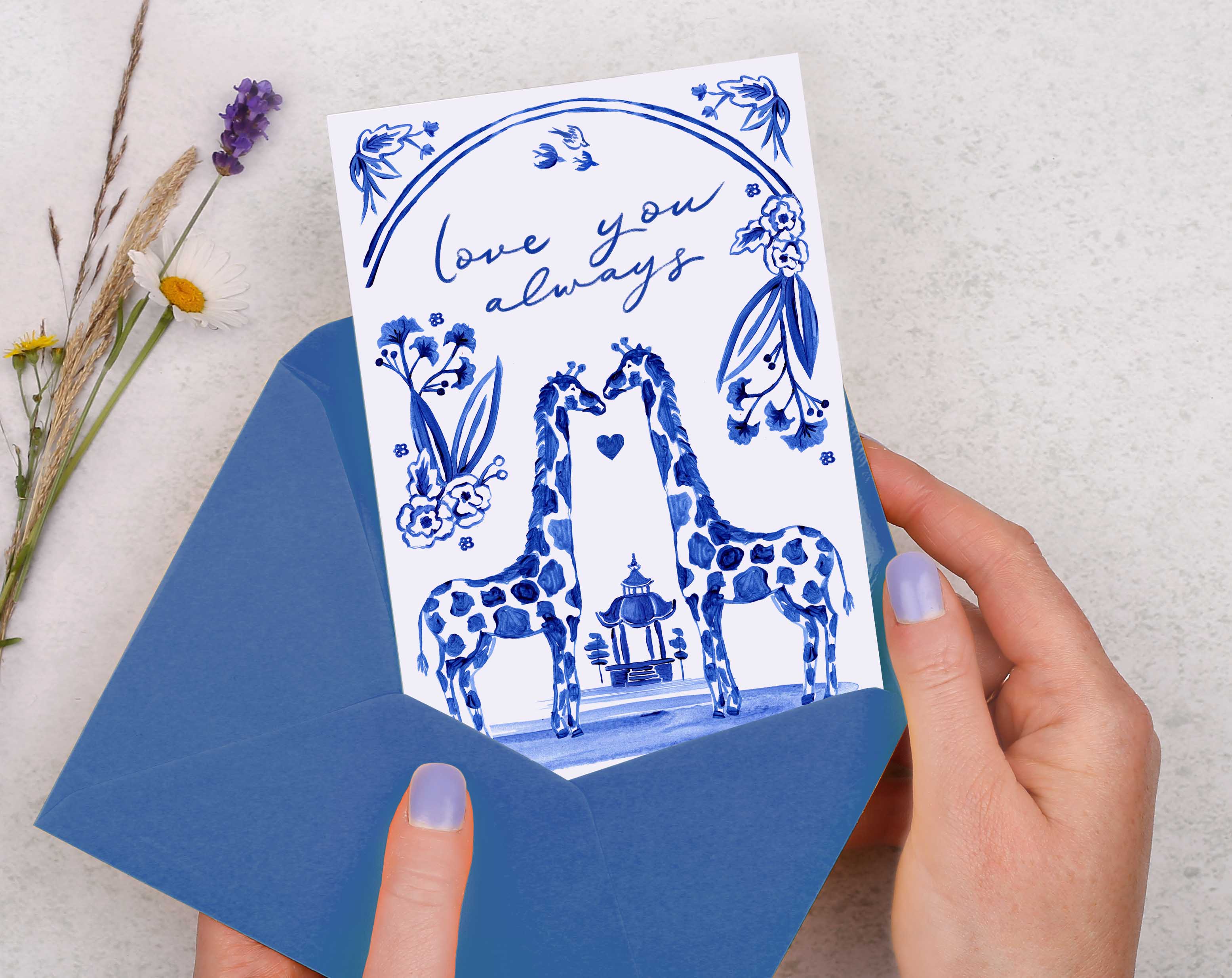 A blue porcelain inspired Anniversary Card with 2 giraffes in love, surrounded by hand painted flowers.
